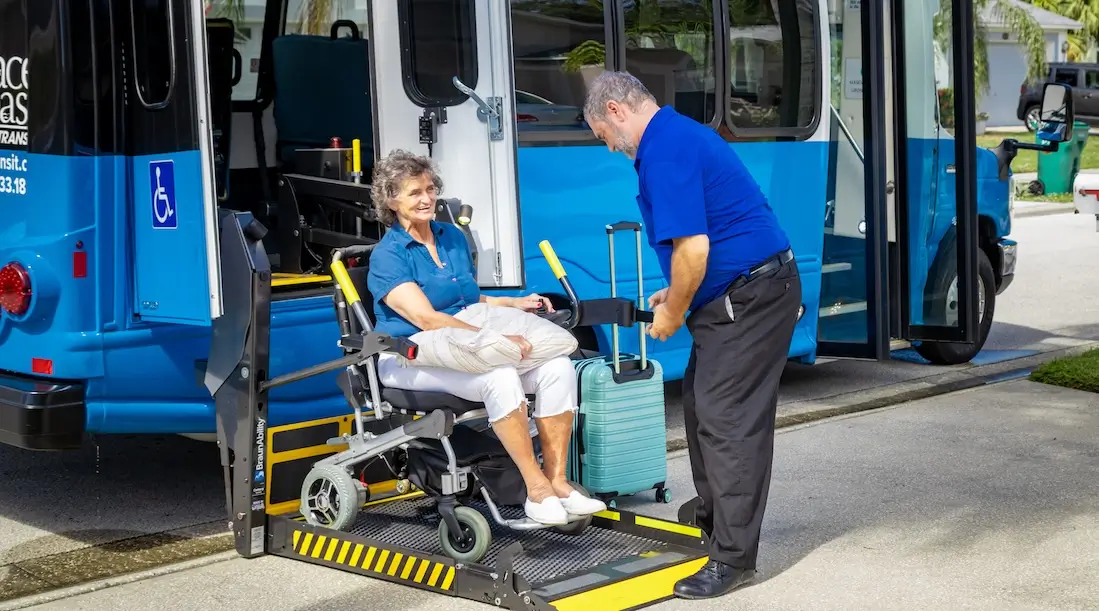 Driver helping evacuee off bus in mobility device