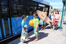 Kids getting of bus going to beach